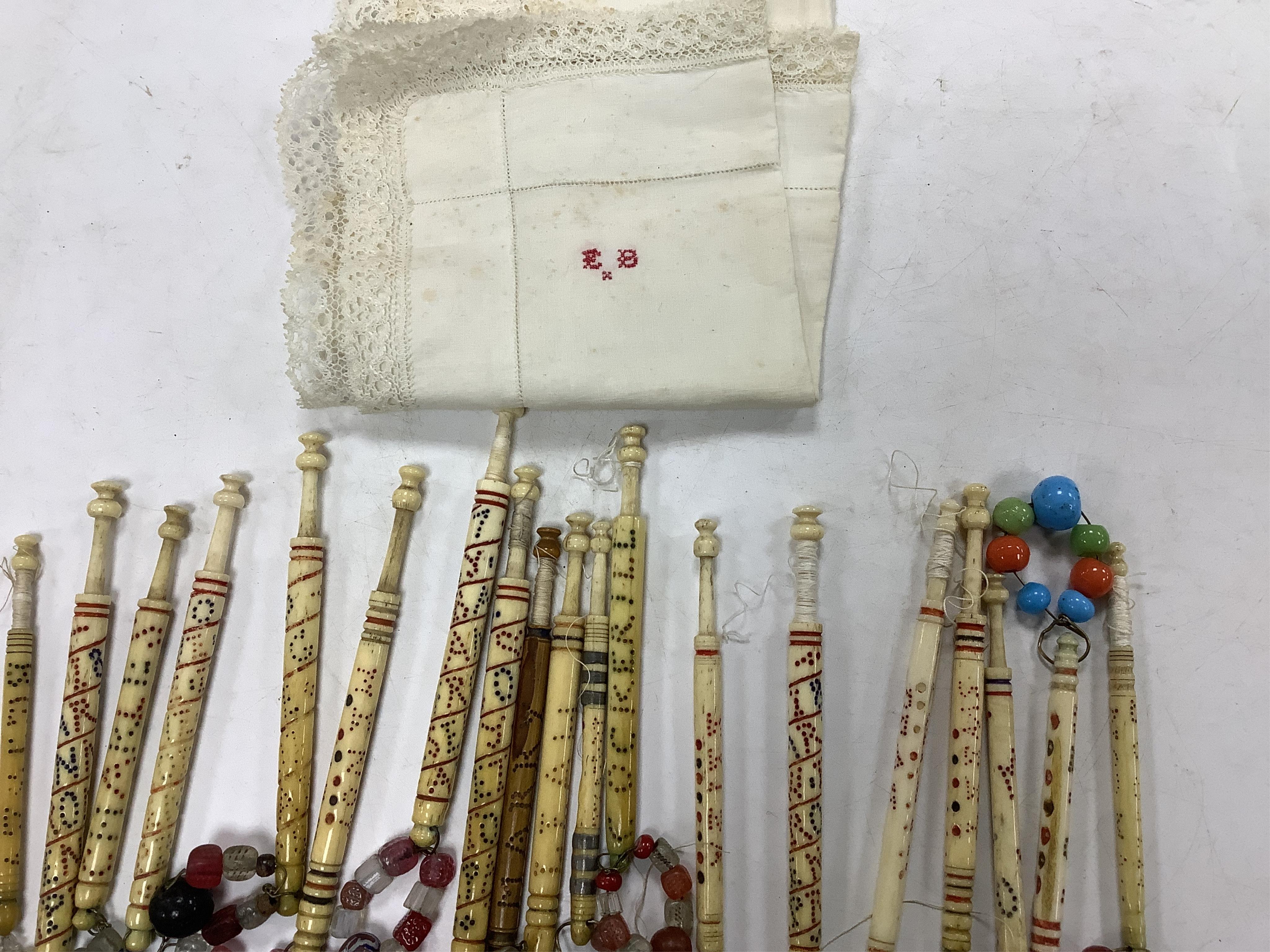 A collection of 19th century named and motto bone lace bobbins, including three named Barry bobbins with a related EB red embroidered monogram to lace edged hankie.(31 bobbins) Condition- light rust staining to hankie, b